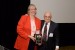 Dr. Nagib Callaos, General Chair, giving Dr. Melinda Connor a plaque "In Appreciation for Delivering a Great Keynote Address at a Plenary Session."